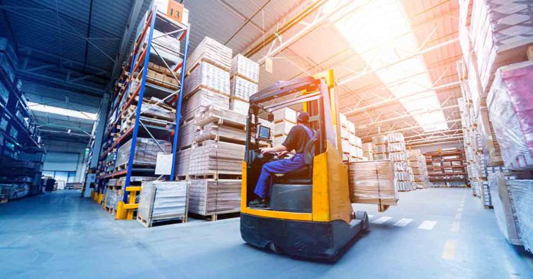 Worker operating warehouse forklift