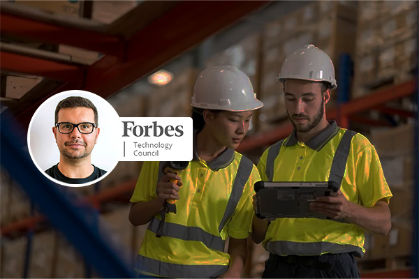 Warehouse workers looking at handheld screen