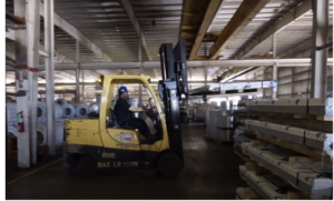 Warehouse worker operating machinery