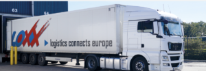 Truck with Loxx logistics connects europe logo leaving warehouse.